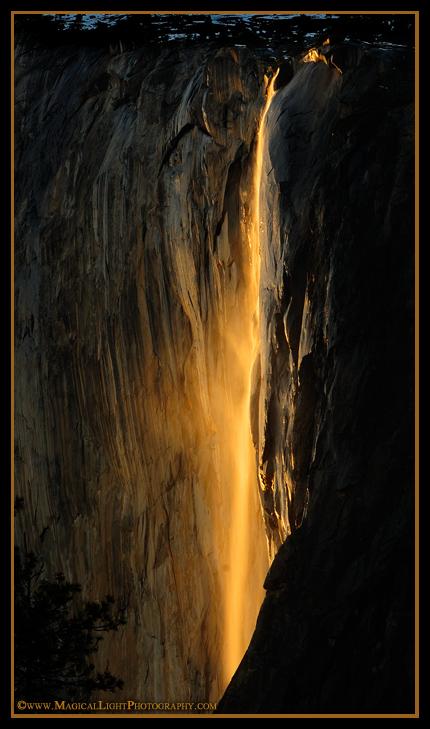 A golden veil of mist is blown away from the rock face of El Capitan during the annual Horsetail Fall "Fire Fall" event.